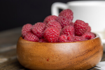 Harvested red ripe raspberries in the kitchen