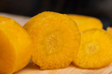 Sliced bright yellow carrots on the table