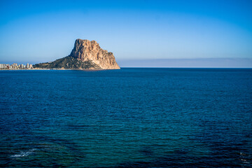 the rock of Ifach and the apartment buildings of the city of Calpe. View with the sea in the foreground