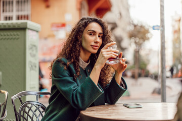 Woman tourist drinking traditional Turkish tea in outdoor cafe