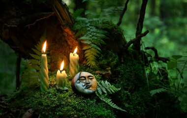 candles and symbolic moon amulet on dark forest background. pagan Wiccan, Slavic traditions for...
