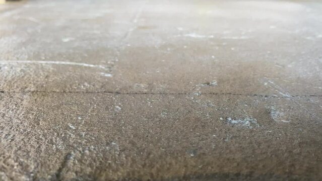 Construction works. 4k video footage with priming the floor surface before further finishing work