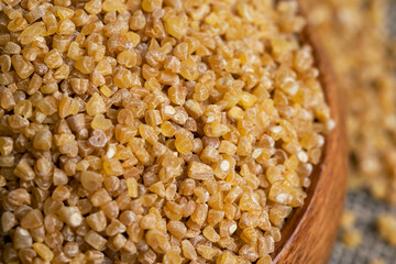 Fresh wheat porridge in a wooden bowl
