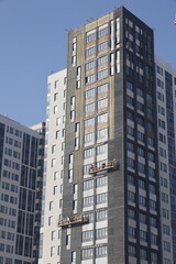Fototapeta premium Construction site background. Hoisting cranes and new multi-storey buildings. I.ndustrial background.