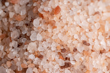 A large number of pink salt crystals of different sizes