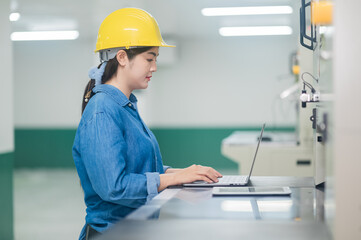 Asian woman are engineer factory inspecting machine in factory  with computer, Asian woman engineer working in factory concept