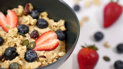 Healthy breakfast, vegan food concept oatmeal porridge bowl with stawberry , blueberry and grains. Clean eating, dieting