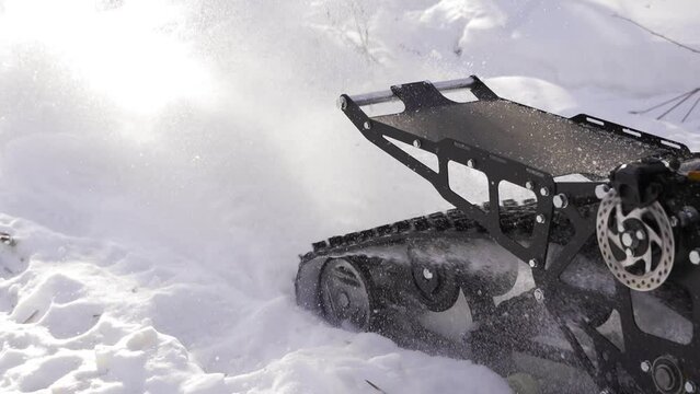 Snow motorcycle rides on snowdrifts. Snowbike skidding in the snow slow motion. Winter transport concept.