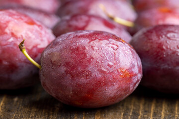 Ripe delicious plums of dark color