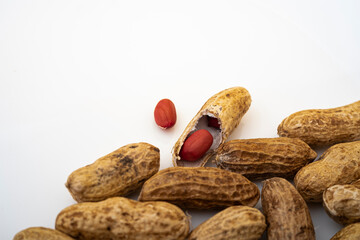 Peanuts in shell isolated on white background. Heap of peanuts close up	
