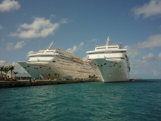 Modern cruiseship cruise ship liners line up in port of Nassau, Bahamas during mass transportation Caribbean cruising holiday vacation in summer