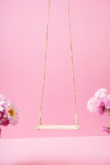 A swing with chrysanthemum flowers as a stand for your cosmetic product