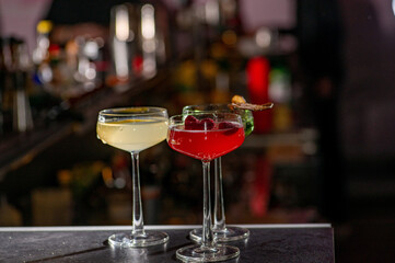 Three colored cocktails on the bar.