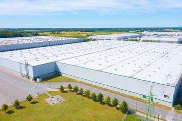 Aerial view of goods warehouse. Logistics center in industrial city zone from above. Aerial view of trucks loading at logistic center stock photo