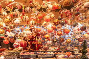 Detail of Christmas balls in a Christmas market stall in the Town Hall Square in Vienna, Austria, at night.