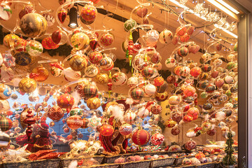 Detail of Christmas balls in a Christmas market stall in the Town Hall Square in Vienna, Austria, at night.