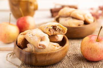 Homemade sweet cookie with apple jam and cup of coffee on white wooden. side view, selective focus.