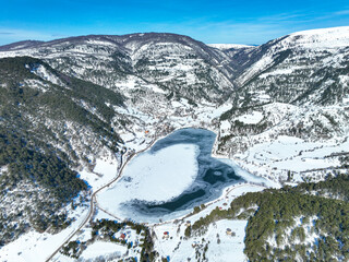 Snowy winter landscape of Goynuk Cubuk lake and windmills with aerial drone. Bolu - Turkey.
