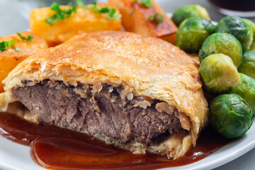 Homemade Beef Wellington with mushroom Duxelles, served with brussels sprouts and Chateau potato