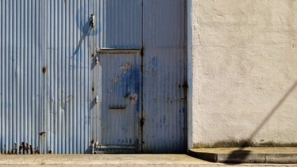 worn industrial metal door on facade