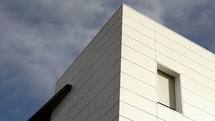 white facade corner against the sky