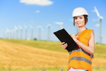 Engineer working at windmill farm, clean energy concept