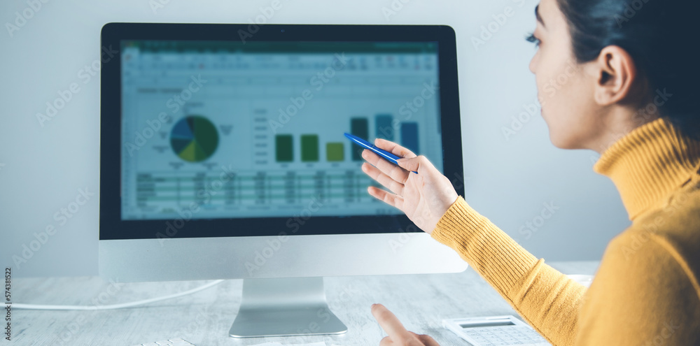 Wall mural woman working in computer with graph in office