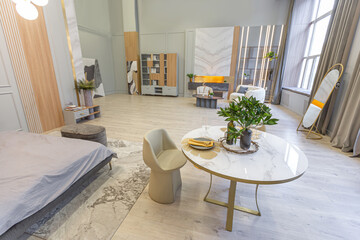 stylish luxury interior of modern studio apartment in green pastel colors with wooden elements. expensive furniture and decorations