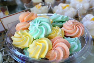 Close up of colored marshmallows in a glass bowl.