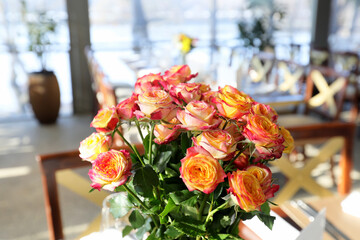 Beautiful colored bouquet of roses on a table.