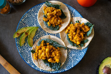 Top view of vegan chickpea tacos with kale on plate