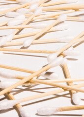 Fototapeta na wymiar Ear sticks, made of bamboo, spread on white surface.