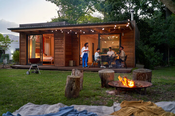 Couple friends enjoying barbecue dinner in summer backyard