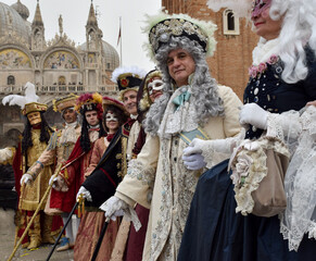 Fototapeta na wymiar Group of men and women dressed up for the Venice carnival with authentic contemporary costumes