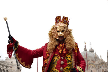 Person dressed up for Carnival of Venice wearing golden lion emblem mask