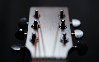 Guitar head and tuning pegs in closeup. Professional acoustic guitar in close up