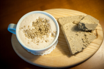 white ceramic cups against blurry background aroma halva