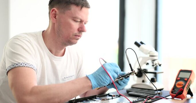 Technician engineer using voltmeter to measure voltage on computer motherboard