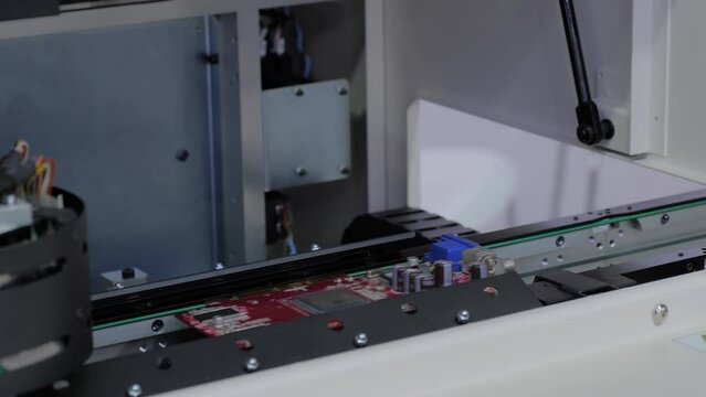 Automated visual optical inspection system for quality control of printed circuit board - close up. Industrial, robotic, measurement, production, technology and manufacturing concept