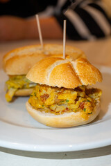 Typical mini burger snack of Basque Country, pinchos or pinxtos, small piece of bread with different toppings, served in bar in San-Sebastian or Bilbao, Spain