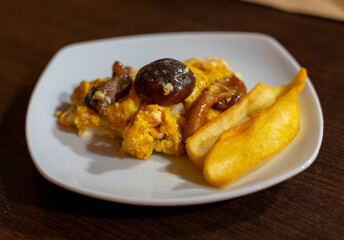 Homemade scrambled eggs with forest mushrooms