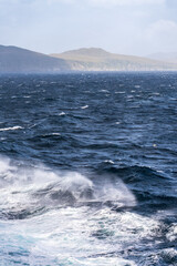 Bow of cruise ship in heavy seas and swell with waves crashing from the front of boat near Cape Horn