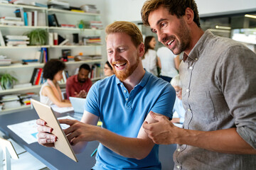 Obraz premium Smiling diverse colleagues gather in boardroom brainstorm discuss financial statistics together