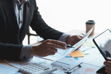 Group of business people meeting for business plan Analyze corporate growth graph and chart to plan business expansion.