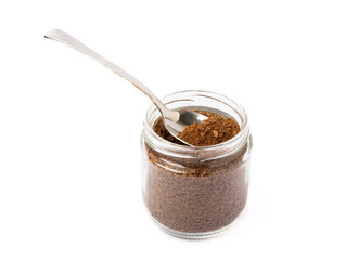 Soluble coffee grains in a glass jar isolated on a white background.