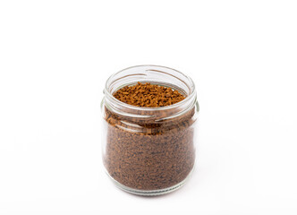 Soluble coffee grains in a glass jar isolated on a white background.
