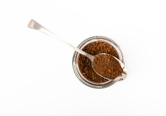 Soluble coffee grains in a glass jar isolated on a white background.
