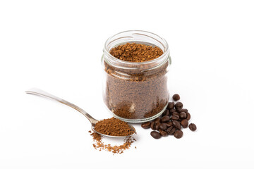 Soluble coffee grains in a glass jar isolated on a white background.