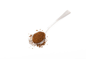 Soluble coffee grains in a spoon isolated on a white background.