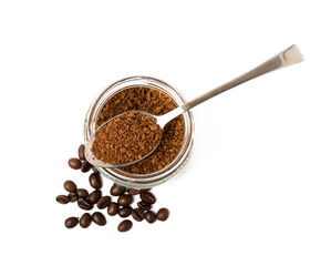 Soluble coffee grains in a glass jar isolated on a white background.